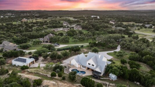 Luxury home in Dripping Springs, Texas featuring Hill Country views, modern finishes, and acreage representative of the Dripping Springs real estate market.